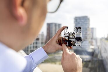 Man holding and pointing at aluminium section sample.