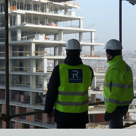 Construction professionals looking out on building project.