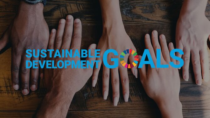 Sustainable Development Goals logo in front of hands reaching out