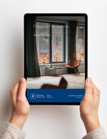 Two hands holding ipad with digital brochure in front of white wall.