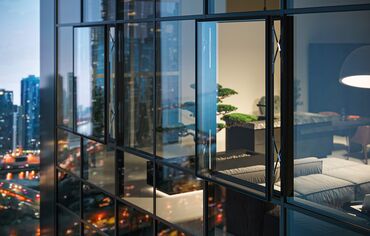 Night view of a high-rise building with an open parallel window in the glass façade.